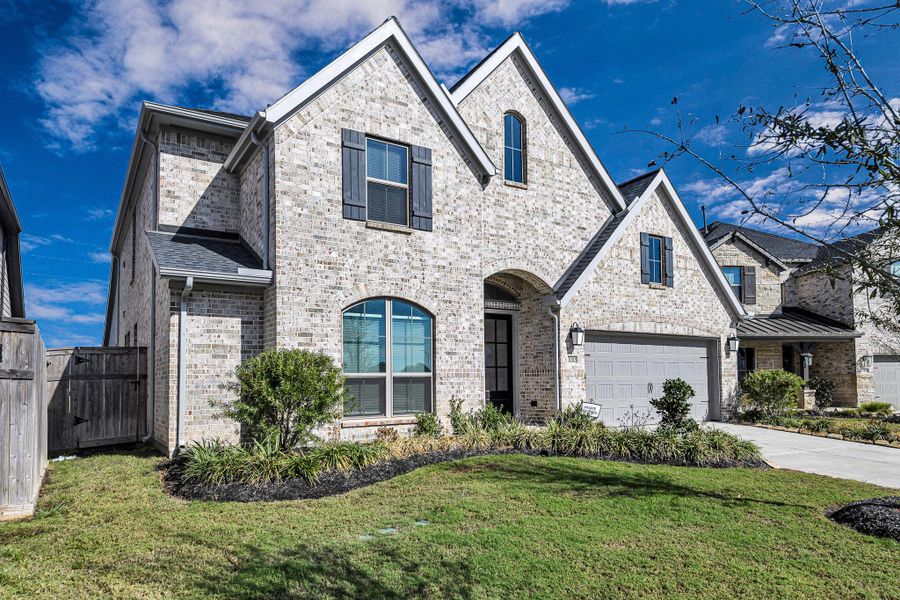 Front exterior of a new home in Cross Creek West 55', Fulshear, TX, highlighting curb appeal (Image 1). Front exterior of a new home in Cross Creek West 55', Fulshear, TX, highlighting curb appeal (Image 1).