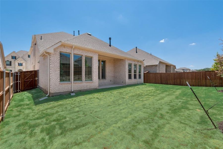 Rear view of property featuring a yard