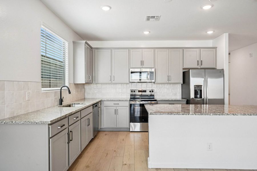 Kitchen featuring the Artisan Collection. Finishes may vary by community.