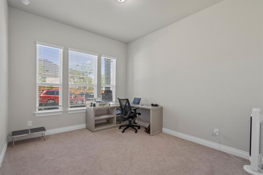 High ceilings and soft carpeting create a quiet atmosphere in this functional workspace.