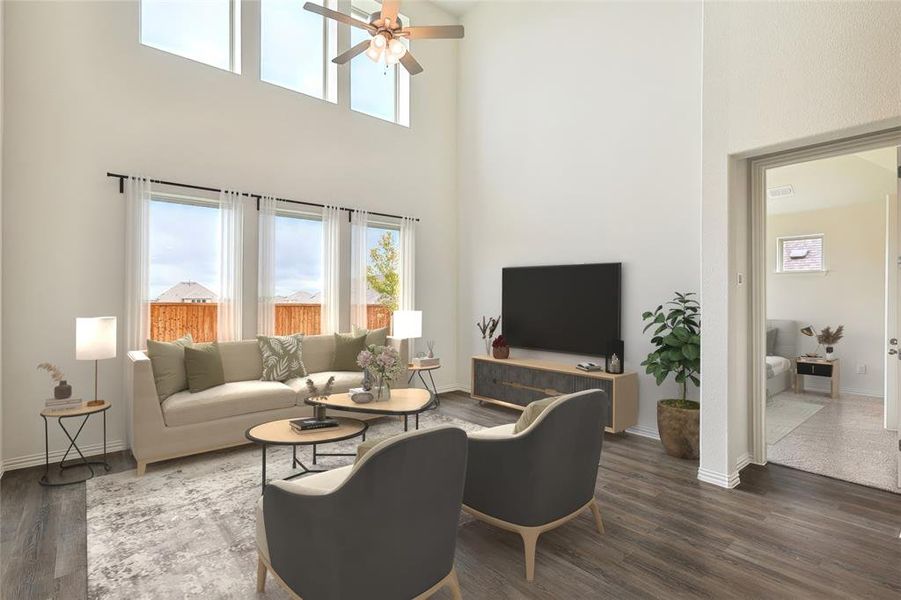 Living room featuring dark hardwood / wood-style floors, a towering ceiling, and ceiling fan