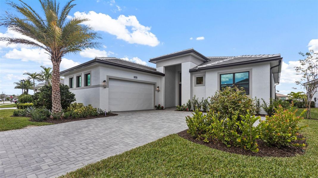 Front exterior of a new home in Cresswind Palm Beach at Westlake, Westlake, FL, highlighting curb appeal (Image 1). Front exterior of a new home in Cresswind Palm Beach at Westlake, Westlake, FL, highlighting curb appeal (Image 1).