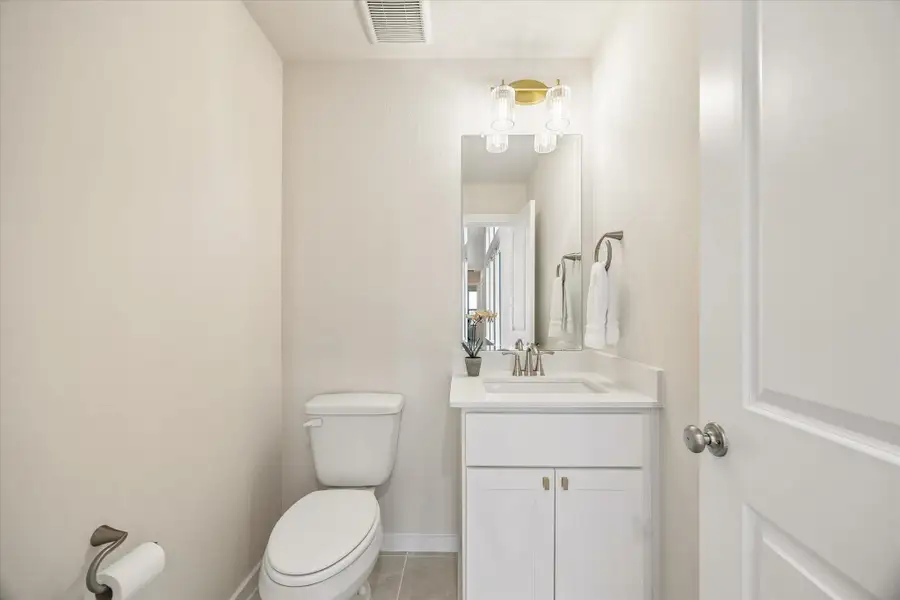 UPSTAIRS POWDER BATH FEATURES A CLEAN, MODERN DESIGN WITH A QUARTZ VANITY, FRAMED MIRROR, AND UPDATED LIGHTING. UPSTAIRS POWDER BATH FEATURES A CLEAN, MODERN DESIGN WITH A QUARTZ VANITY, FRAMED MIRROR, AND UPDATED LIGHTING.