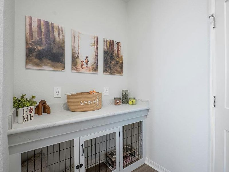 A mudroom with a drop zone counter and coat closet is located at the garage entry - Monroe by Highland Homes