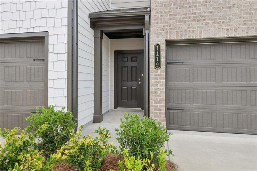 Front exterior of a new home in Laurelwood, Douglasville, GA, highlighting curb appeal (Image 14).