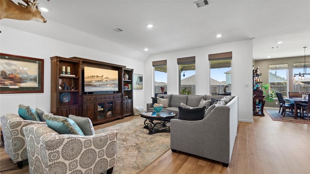 Wow—this spacious family room feels open, bright, and full of possibilities. Upgraded blinds, clean lines, and beautiful flooring create a stylish, comfortable space for relaxing and gathering. Wow—this spacious family room feels open, bright, and full of possibilities. Upgraded blinds, clean lines, and beautiful flooring create a stylish, comfortable space for relaxing and gathering.