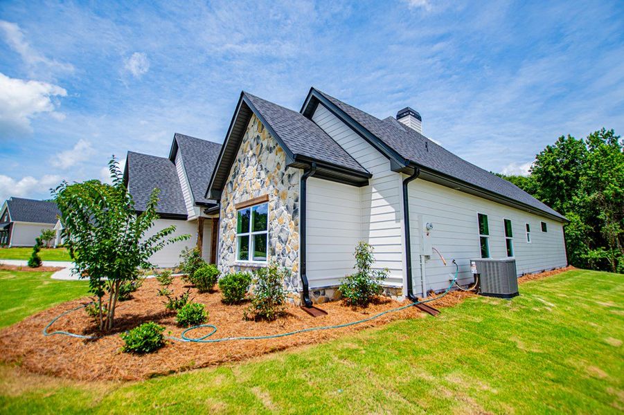 Front exterior of a new home in WOODMONT RESERVE, Roopville, GA, highlighting curb appeal (Image 30).