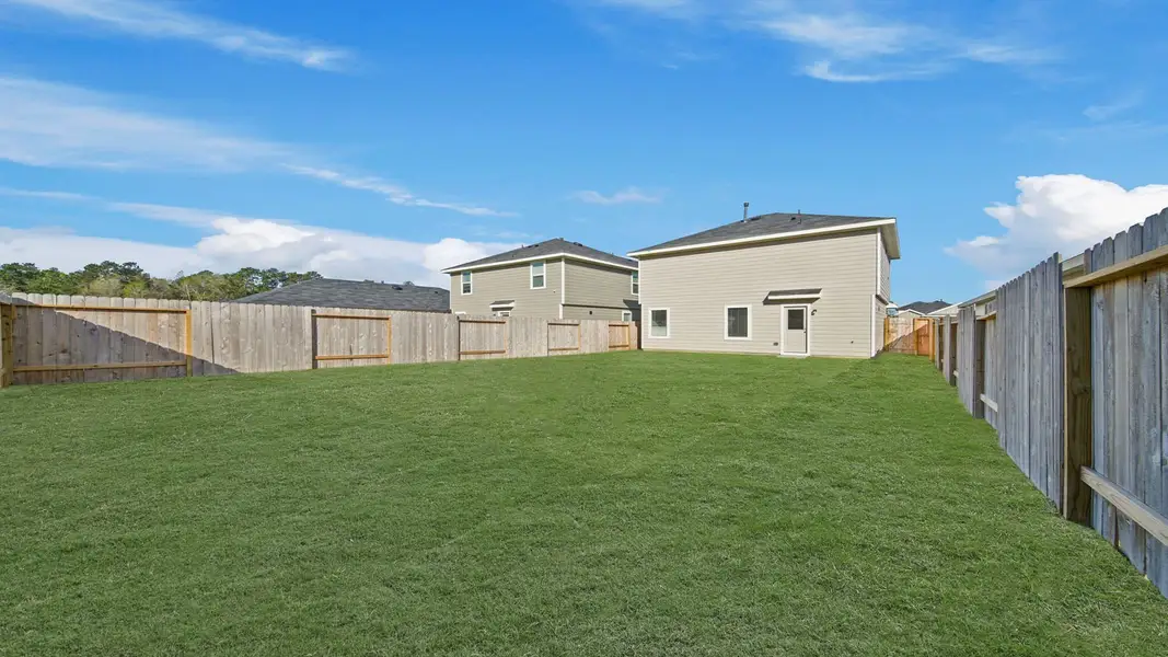 Exterior details and patio area of a home in The Canopies, Splendora (Image 4).