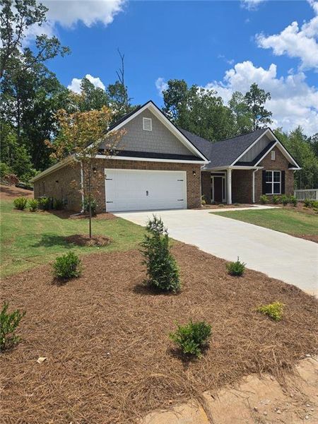 Front exterior of a new home in Mirror Lake at South Harbour, Villa Rica, GA, highlighting curb appeal (Image 19). Front exterior of a new home in Mirror Lake at South Harbour, Villa Rica, GA, highlighting curb appeal (Image 19).