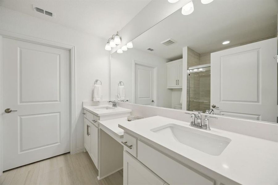 View of the primary en suite bathroom. The walk-in closet is through the door shown.