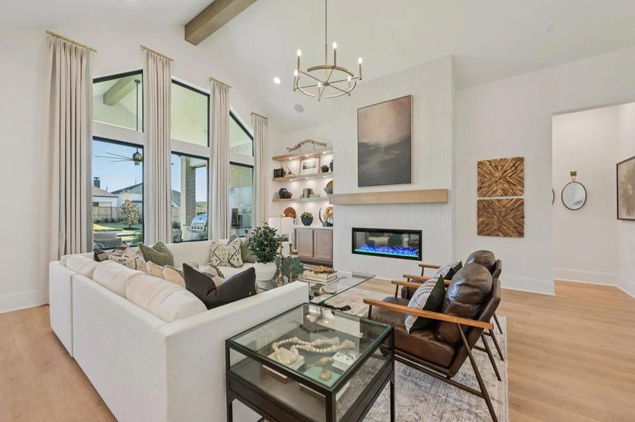 Natural light floods this living room, featuring soaring ceilings and a contemporary fireplace. Natural light floods this living room, featuring soaring ceilings and a contemporary fireplace.