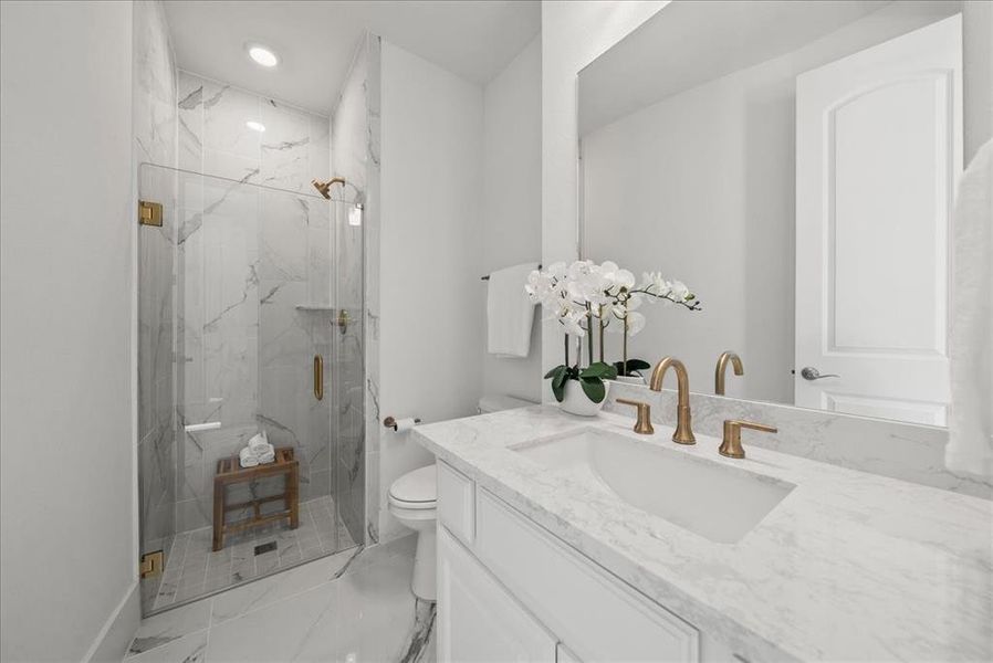 Bathroom featuring light marble floors, vanity, a glass shower, and recessed lighting Bathroom featuring light marble floors, vanity, a glass shower, and recessed lighting