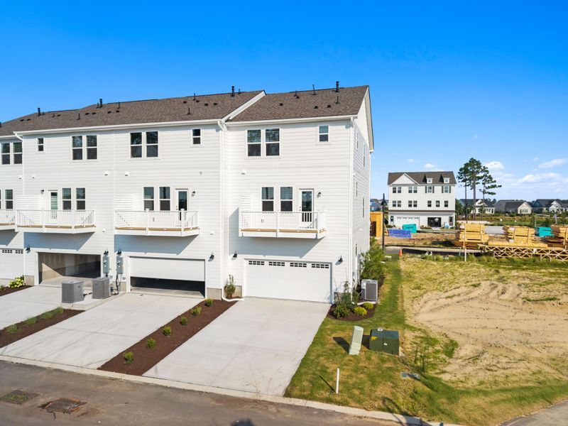 Front exterior of a new home in Lakeside Townes at Riverlights, Wilmington, NC, highlighting curb appeal (Image 18).