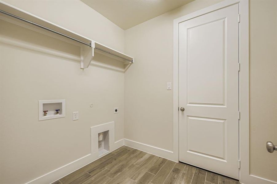 Washroom featuring wood tiled floors, hookup for an electric dryer, hookup for a washing machine, and gas dryer hookup