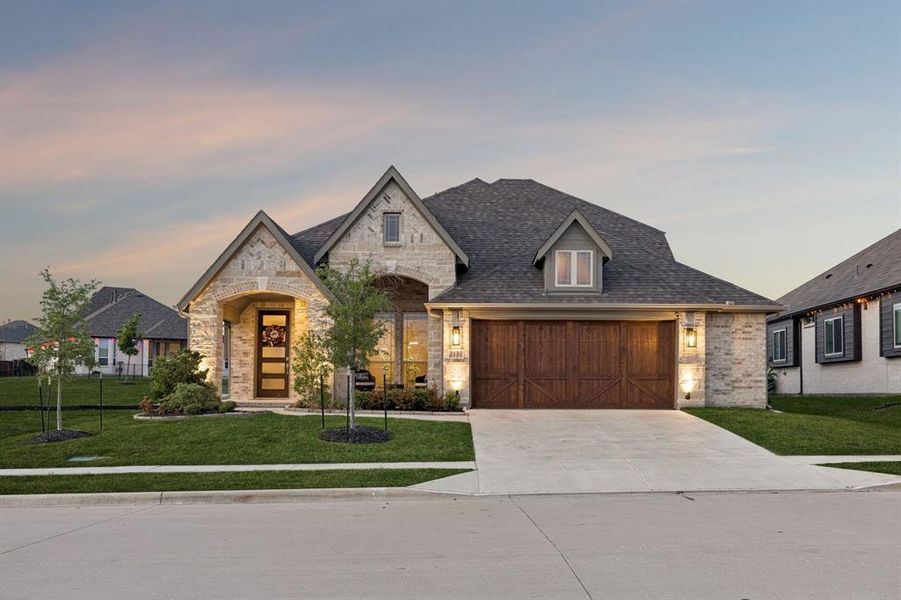 Front exterior of a new home in Devonshire, Forney, TX, highlighting curb appeal (Image 2). Front exterior of a new home in Devonshire, Forney, TX, highlighting curb appeal (Image 2).