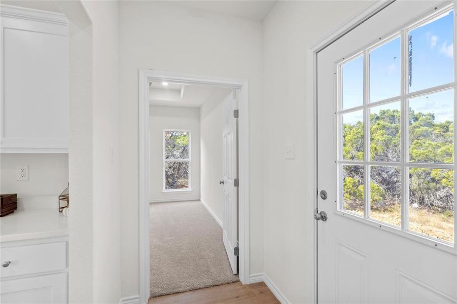 Doorway featuring carpet flooring and wood finished floors Doorway featuring carpet flooring and wood finished floors