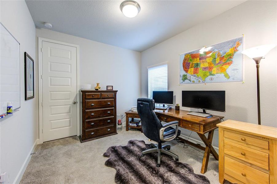 SECOND BEDROOM downstairs currently transformed in a working area.