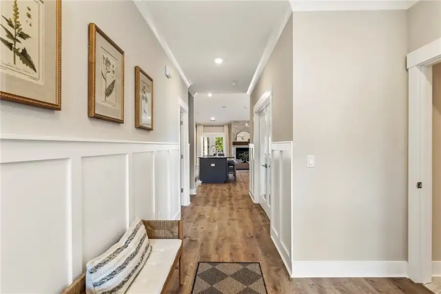 This inviting hallway features wainscoting and har