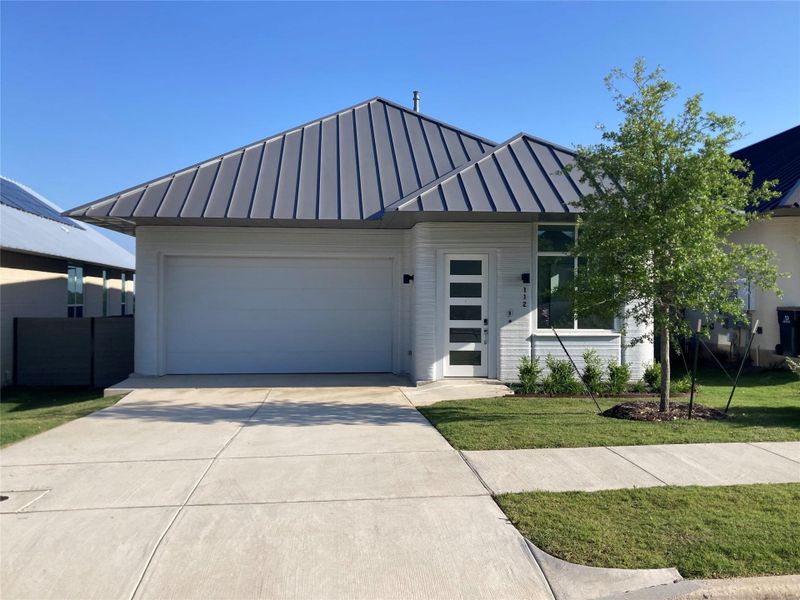 Front exterior of a new home in Wolf Ranch: Genesis Collection, Georgetown, TX, highlighting curb appeal (Image 1). Front exterior of a new home in Wolf Ranch: Genesis Collection, Georgetown, TX, highlighting curb appeal (Image 1).