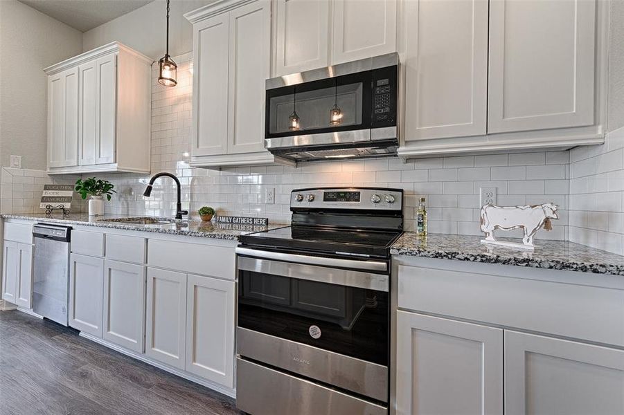 Granite counters and stainless appliances are standard