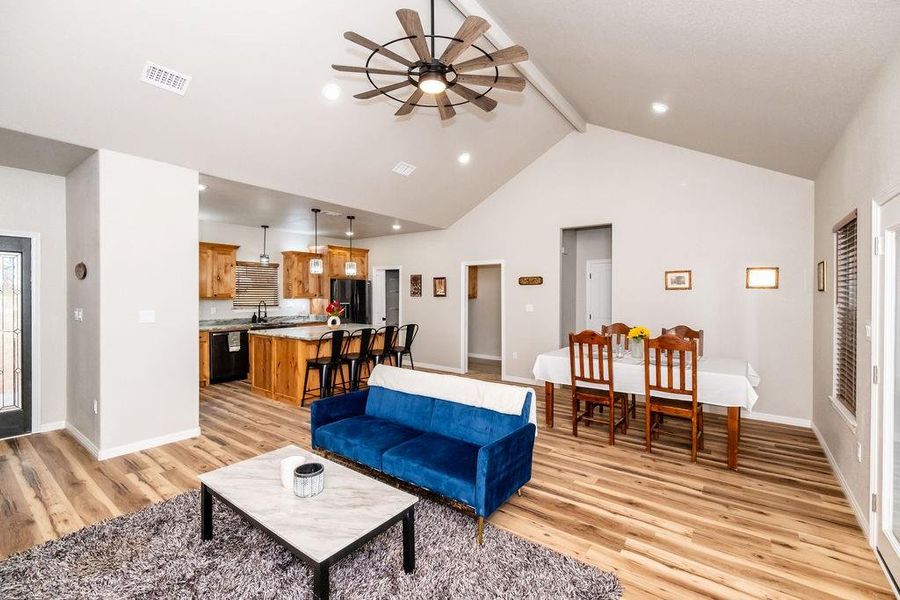 Living room with ceiling fan, beam ceiling, sink, and light hardwood / wood-style flooring