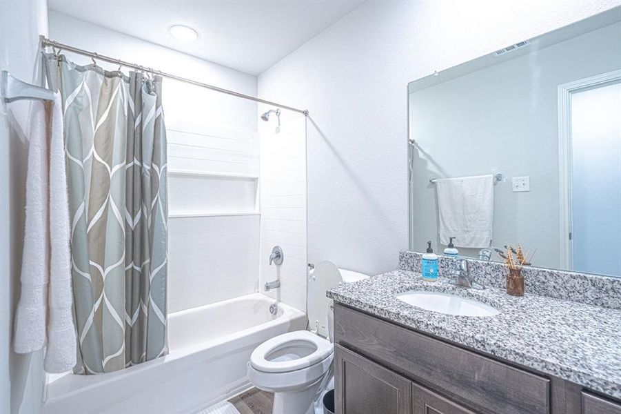 Bathroom featuring shower / bath combo and vanity