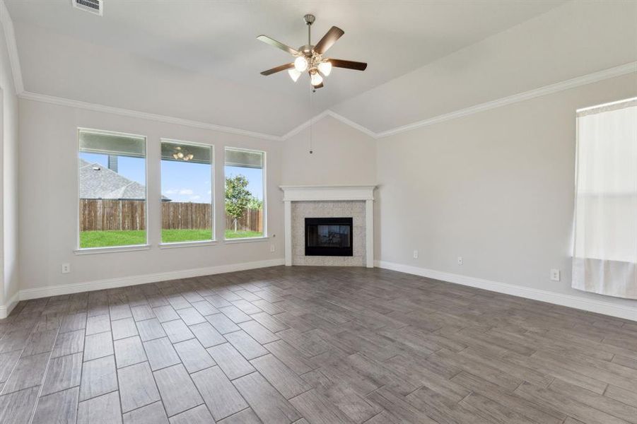 Family time is easily present in this room's footprint. Winter evenings warmed up with the gas log fireplace. Other features include the crown molding, vaulted ceiling & views of the large backyard from the oversized windows. Family time is easily present in this room's footprint. Winter evenings warmed up with the gas log fireplace. Other features include the crown molding, vaulted ceiling & views of the large backyard from the oversized windows.