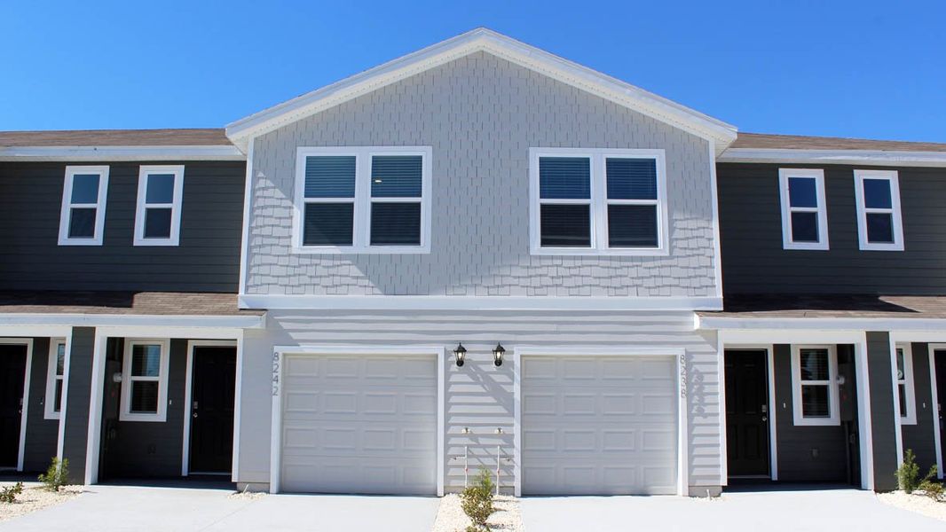 Representative exterior photo of a completed home built from the PEARSON - Interior Unit by D.R. Horton in The Towns at Laurel Commons, Ocala, FL (Image 1).