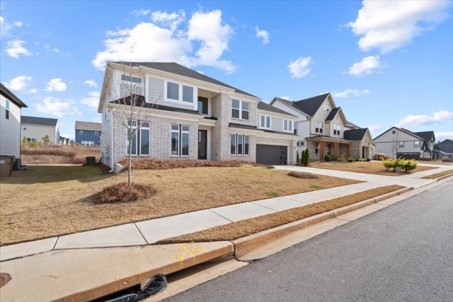 Front exterior of a new home in Twin Lakes, Hoschton, GA, highlighting curb appeal (Image 2).