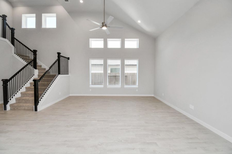 Gather the family and guests together in your lovely living room! Featuring soaring high ceilings, recessed lighting, ceiling fan, custom paint, gorgeous floors, and large windows that provide plenty of natural lighting throughout the day. Sample photo of completed home with similar floor plan. Actual colors and selections may vary. Gather the family and guests together in your lovely living room! Featuring soaring high ceilings, recessed lighting, ceiling fan, custom paint, gorgeous floors, and large windows that provide plenty of natural lighting throughout the day. Sample photo of completed home with similar floor plan. Actual colors and selections may vary.