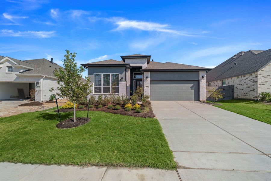 Front exterior of a new home in Artavia, Conroe, TX, highlighting curb appeal (Image 1).