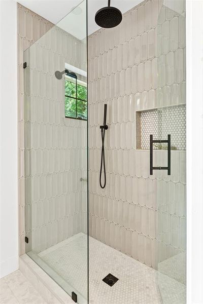 Bathroom with a walk in shower and tile patterned flooring