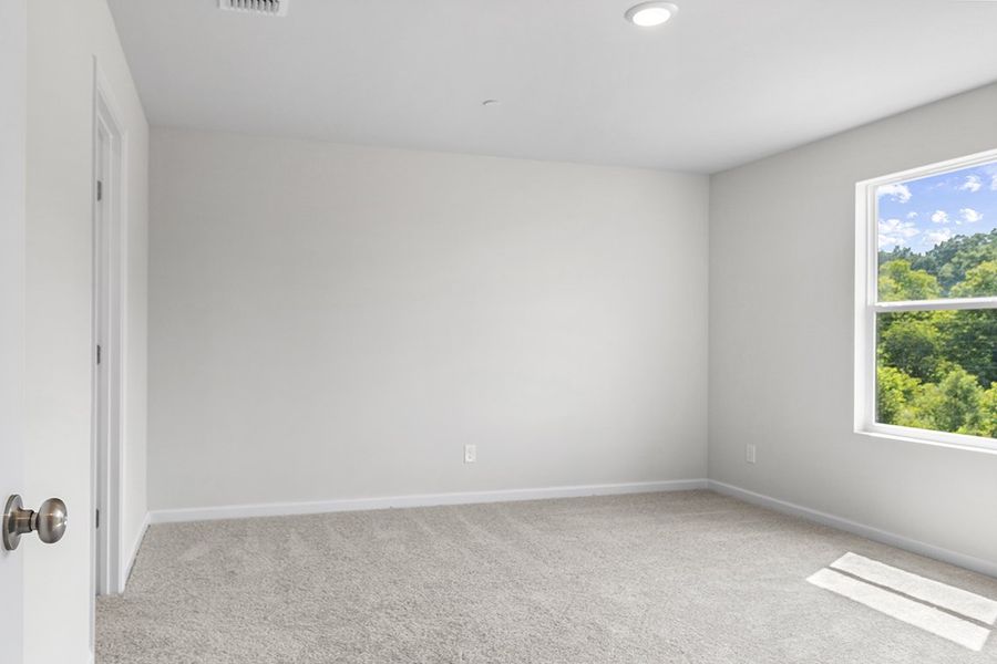 A room with a carpet and a window. A room with a carpet and a window.