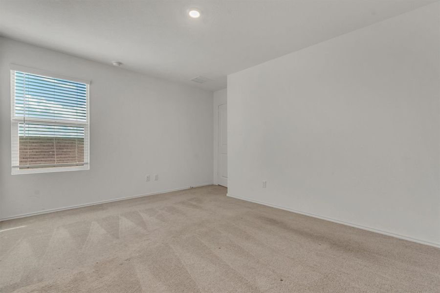 Soft carpeting underfoot defines this versatile bedroom space featuring tall ceilings. Soft carpeting underfoot defines this versatile bedroom space featuring tall ceilings.