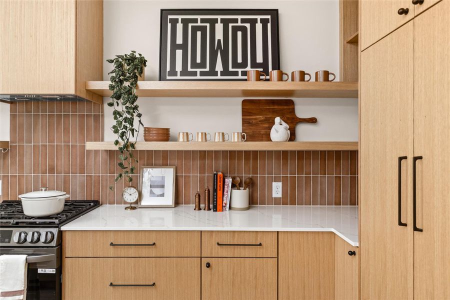 Kitchen featuring light brown cabinets, stainless steel gas range oven, open shelves, and range hood