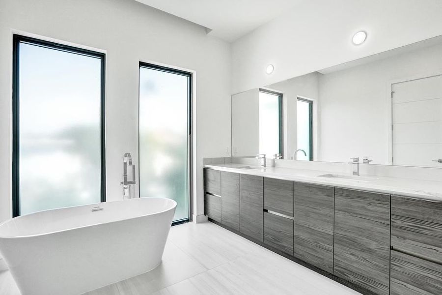 Primary Bathroom — Spa-inspired retreat featuring custom cabinetry, dual vanities, beautifully designed shower , and a soaking tub filled with natural light. Perfect for unwinding together, enjoying a glass of wine in the tub, or creating a serene, at-home spa experience.