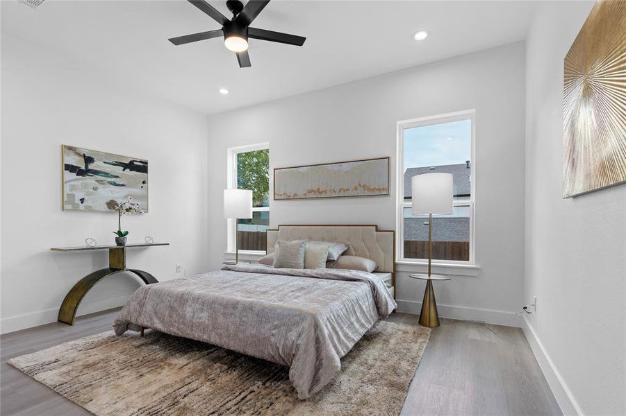 Bedroom featuring wood finished floors, a ceiling fan, and recessed lighting Bedroom featuring wood finished floors, a ceiling fan, and recessed lighting