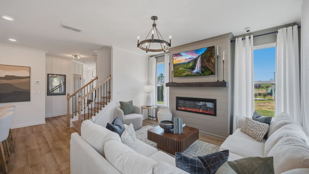 Open family living space with electric fireplace and modern finishes in Langley Overlook new construction townhome. Open family living space with electric fireplace and modern finishes in Langley Overlook new construction townhome.