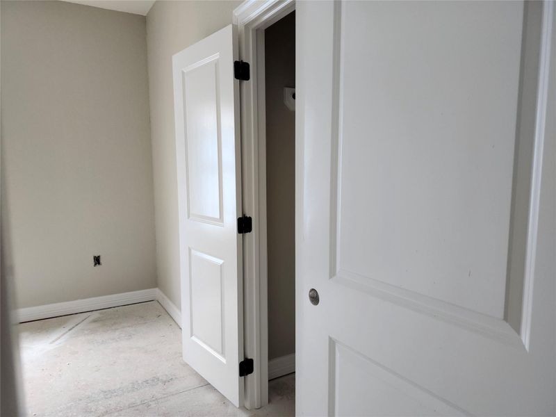 This photo shows a bedroom with light-painted walls and baseboards.