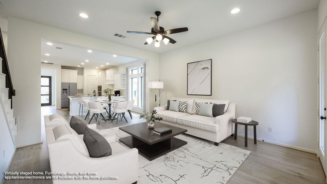 Living room with recessed lighting, light wood-type flooring, and ceiling fan Living room with recessed lighting, light wood-type flooring, and ceiling fan