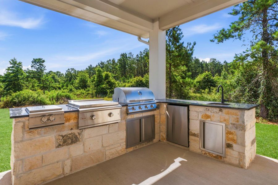 Outdoor kitchen with grill, two additional burners, griddle, refrigerator and sink Outdoor kitchen with grill, two additional burners, griddle, refrigerator and sink
