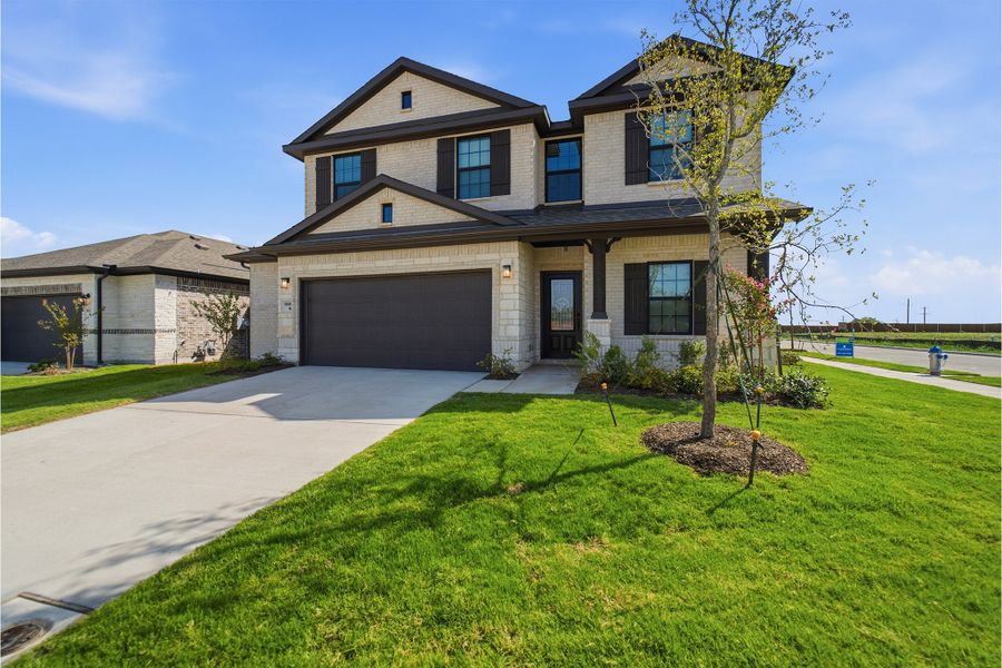 Front exterior of a new home in Heartland, Crandall, TX, highlighting curb appeal (Image 2).