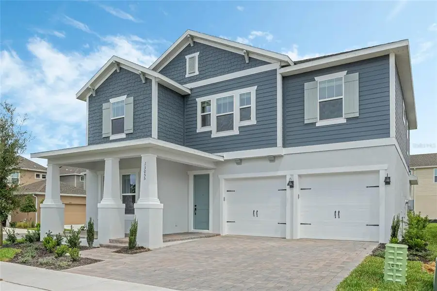 Front exterior of a new home in Northlake At Ovation, Winter Garden, FL, highlighting curb appeal (Image 1). Front exterior of a new home in Northlake At Ovation, Winter Garden, FL, highlighting curb appeal (Image 1).