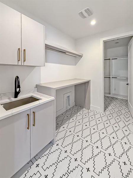 Laundry room with a sink and recessed lighting Laundry room with a sink and recessed lighting