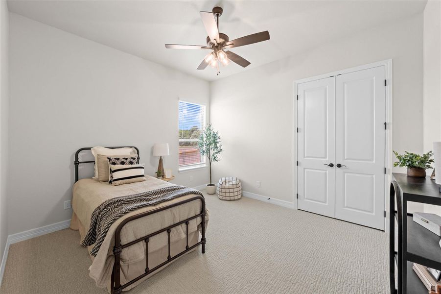 A tranquil bedroom with high ceilings features a ceiling fan, a window, and soft carpeting. A tranquil bedroom with high ceilings features a ceiling fan, a window, and soft carpeting.