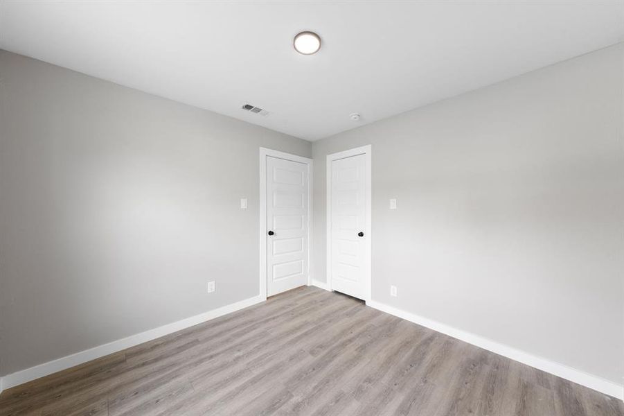 Spare room featuring baseboards and wood finished floors Spare room featuring baseboards and wood finished floors