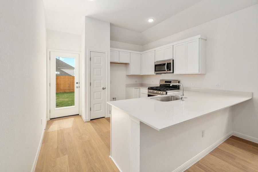 Kitchen in the Ash home plan by Trophy Signature Homes – REPRESENTATIVE PHOTO Kitchen in the Ash home plan by Trophy Signature Homes – REPRESENTATIVE PHOTO