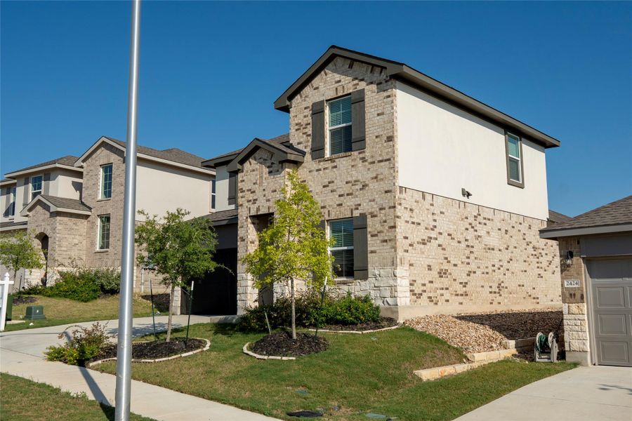 Front exterior of a new home in Bar W Ranch, Leander, TX, highlighting curb appeal (Image 23).