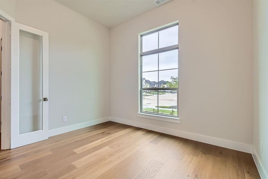 Spare room with plenty of natural light and light wood-type flooring Spare room with plenty of natural light and light wood-type flooring