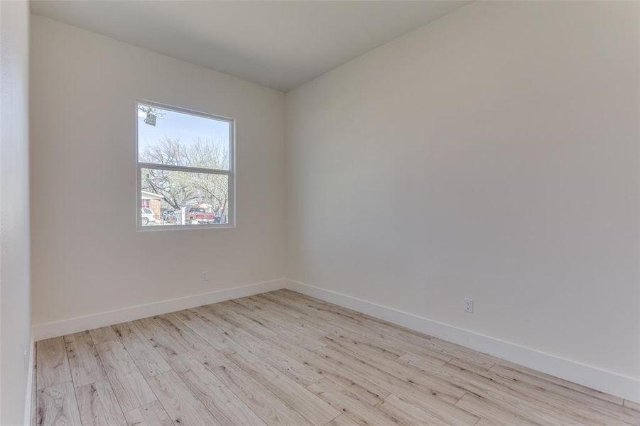 Empty room with baseboards and wood finished floors